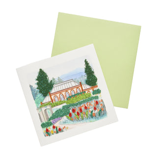A square note card featuring a colorful paper illustration of botanical gardens with a greenhouse, tall trees, and rows of red and orange tulips. With green card evelope, set against a clean white background