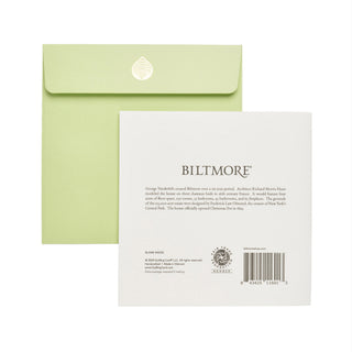 A light green envelope with a gold crest sits behind a white Biltmore brand insert card showing printed text, the Biltmore logo, and a barcode on a plain white background.