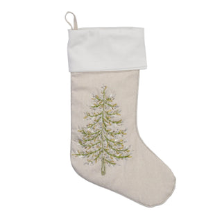 A beige fabric Christmas stocking with a white cuff and a green and white embroidered pine tree, shown against a plain white background.