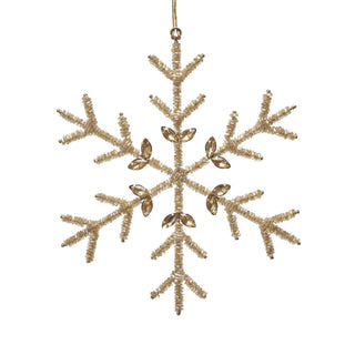 A gold snowflake Christmas ornament made of textured tinsel with six clear faceted crystal accents, hanging from a gold string against a plain white background.