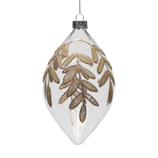 A clear glass Christmas ornament shaped like a teardrop, decorated with a glittery gold leaf branch design, shown against a plain white background.