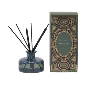Archipelago reed diffuser set featuring a smoky blue glass bottle with black reeds alongside its ornate olive green and gold packaging box.
