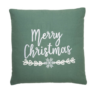 A square sage green throw pillow featuring the words 'Merry Christmas' in white script, a white snowflake, and a white leafy branch motif on a plain white background.