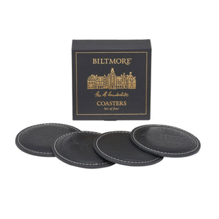 Four black leather coasters with white stitching arranged in front of a black Biltmore box with gold lettering on a white background.