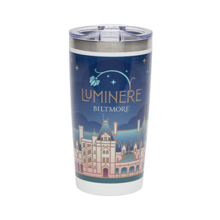 A stainless steel travel tumbler with a clear lid, featuring a printed design of the Luminere Biltmore castle under a dark blue night sky with stars.