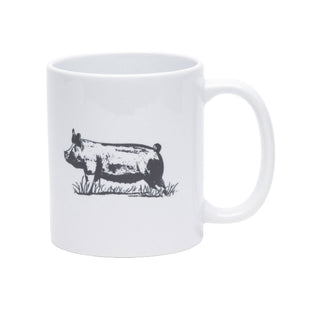 A white ceramic mug featuring a black ink-style illustration of a pig standing in grass, shown on a plain white background.