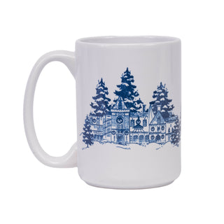 A white ceramic mug with a blue illustrated graphic of Biltmore house in the winter with pine trees and snow, shown on a plain white background.